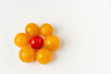 Cherry tomatoes on white paper background. Top view