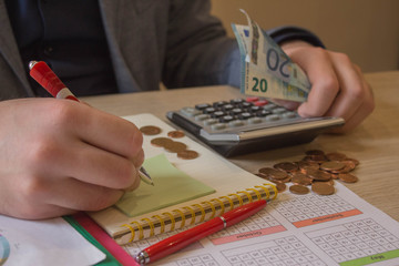 Man using calculator and calculate bills in home office. business financial accounting