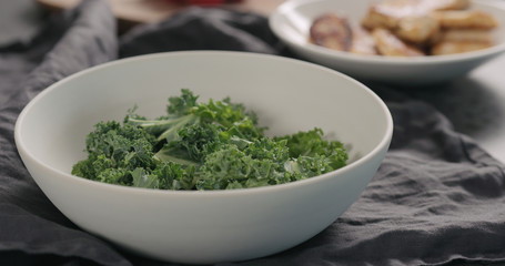 kale leaves in white bowl on countertop