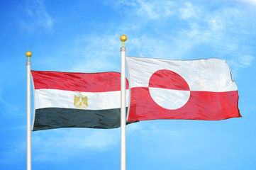 Egypt and Greenland two flags on flagpoles and blue cloudy sky