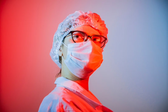 Woman Doctor Virologist, Infectious Disease, Epidemiologist, Dramatic Portrait, Wearing A Medical Mask Against Coronavirus