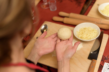 Girl shows a blank of dough for khachapuri