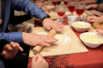 Men's hands roll dough for khachapuri