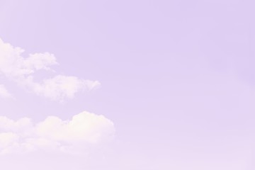 Fototapeta premium Beautiful white soft fluffy clouds on a pale violet sky background