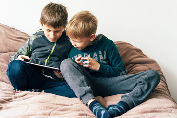 Teenage boys chat online via video chat. Online communication from home. The concept of quarantine and self-isolation in an epidemic. Staying at home.