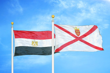 Egypt and Jersey two flags on flagpoles and blue cloudy sky