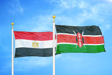 Egypt and Kenya two flags on flagpoles and blue cloudy sky