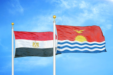 Egypt and Kiribati two flags on flagpoles and blue cloudy sky