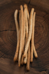 Traditional italian snack - grissini on walnut surface