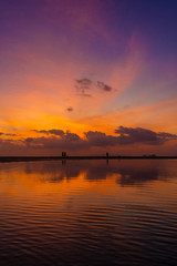 Burning bright sky during sunset on a tropical beach. Sunset during the exodus, the strength of people walking on water