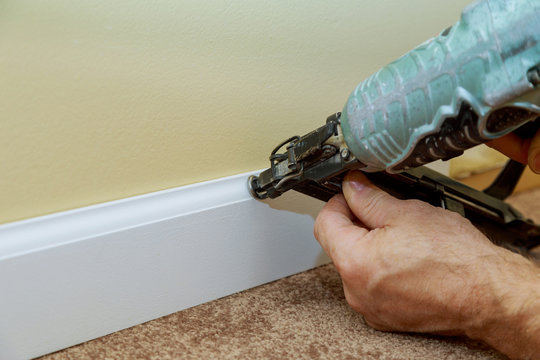 Carpenter Brad Using Nail Gun To Base Moulding Trim, With Room Renovation New House Finishing