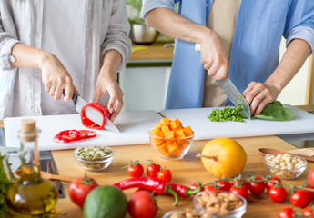 Obraz na płótnie Canvas Couple cooking dinner from fresh vegetables and pumpkin