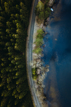 Overhead of road by the lake and the forest