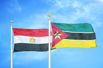 Egypt and Mozambique two flags on flagpoles and blue cloudy sky