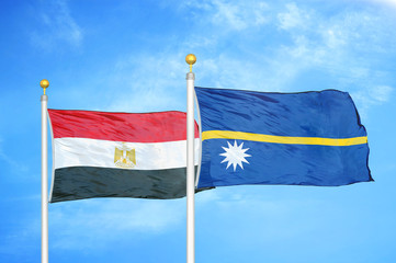 Egypt and Nauru two flags on flagpoles and blue cloudy sky