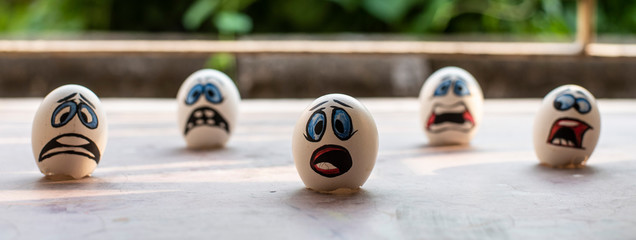 Eggshells painted as face animation to represent Corona virus and the victims. Animation art and...