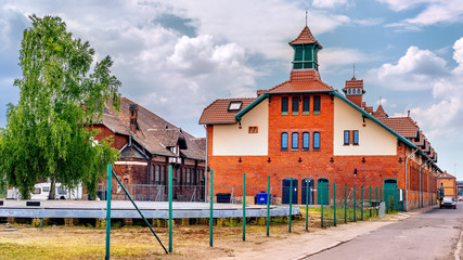 Old ruined port stables and renovated slaughterhouse buildings from early 1900s in Szczecin harbour. Customs wharf and Stettin Boulevards, Poland