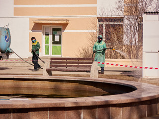 Karaganda, Kazakhstan -Meticulous disinfection and decontamination on the streets as a prevention against Coronavirus disease (SARS-Cov-2), COVID-19 outbreak. workers in protective clothing