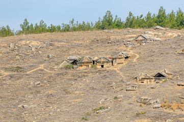 Half buried Roman burial tombs at Hieropolis, Pamakkule, Turkey