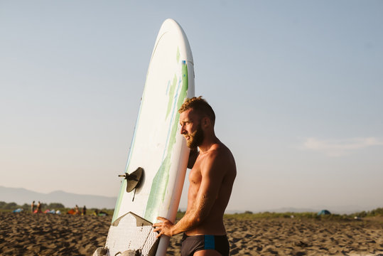 Portrait of young man at the beach. Man is preparing for kite surfing