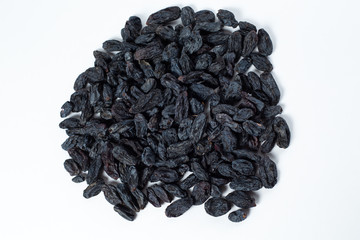 black raisins lies on a white background