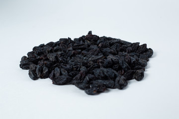 black raisins lies on a white background