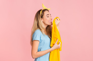 Funny housewife smelling clean tshirt, free space - obrazy, fototapety, plakaty
