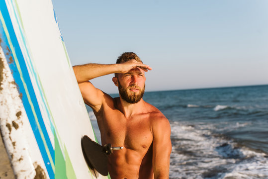 Portrait of young man at the beach. Man is preparing for kite surfing