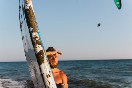 Portrait of young man at the beach. Man is preparing for kite surfing