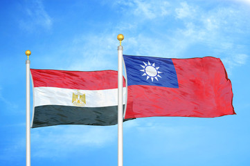 Egypt and Taiwan two flags on flagpoles and blue cloudy sky