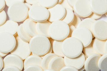 Lot of white round pills, background textures