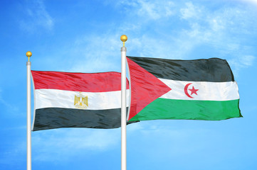 Egypt and Western Sahara two flags on flagpoles and blue cloudy sky