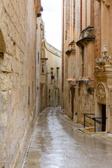 Obraz premium Narrow street in heavy rain, Mdina, Malta