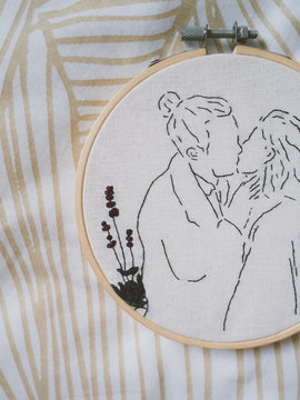 Embroidery frame girl boy kiss 