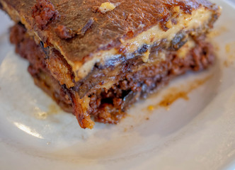 delicious Greek mousaka close up, gourmet plate with minced meat, eggplants, potatoes and bechamel