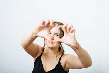 woman making a hand heart frame