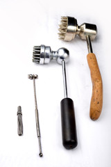 Four different old antique acupuncture hammers for chinese plum therapy on a white background.