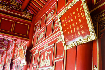 Ornate wooden panels painted red and gold inside Điện Cần Chánh (Can Chanh Palace) Hoàng...