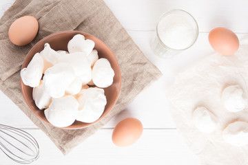 Fototapeta na wymiar Baked meringue with ingredients on white background. Top view