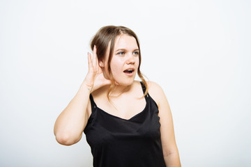 Overhears a woman, tries to listen.