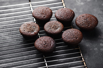 Chocolate cupcakes, muffins with banana and nuts, on a black table and a dark background. Top view, side view. Close-up and medium plan. Space for text.