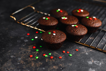 Chocolate cupcakes, muffins with banana and nuts, on a black table and a dark background. Top view, side view. Close-up and medium plan. Space for text.