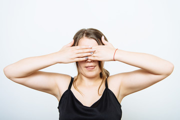 woman closes eyes with her hands