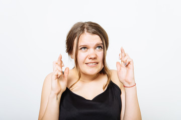 Young woman with fingers crossed