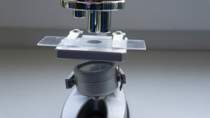 silver microscope in the sunlight from the window