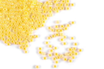 Isolated beads on a white background, scattered beads, yellow beads