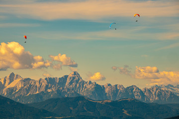 Panorama of the Austrian Alps,Europe,at Lake Ossiacher See with the mountains of the Karawanken Mountains with paragliders