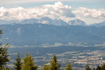 Panorama of the Austrian Alps,Europe,at Lake Ossiacher See with the mountains of the Karawanken Mountains with paragliders