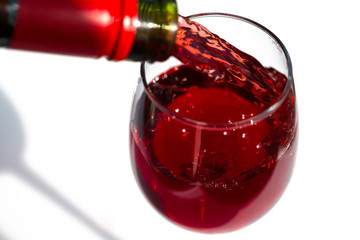 Pouring red wine. isolated on white. Save space, blur in fast motion.