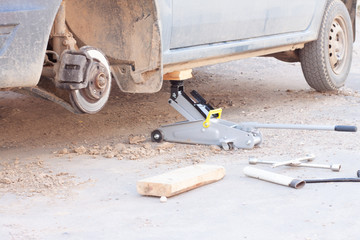 replacement of wheels on the car.Lifting the car with a Jack